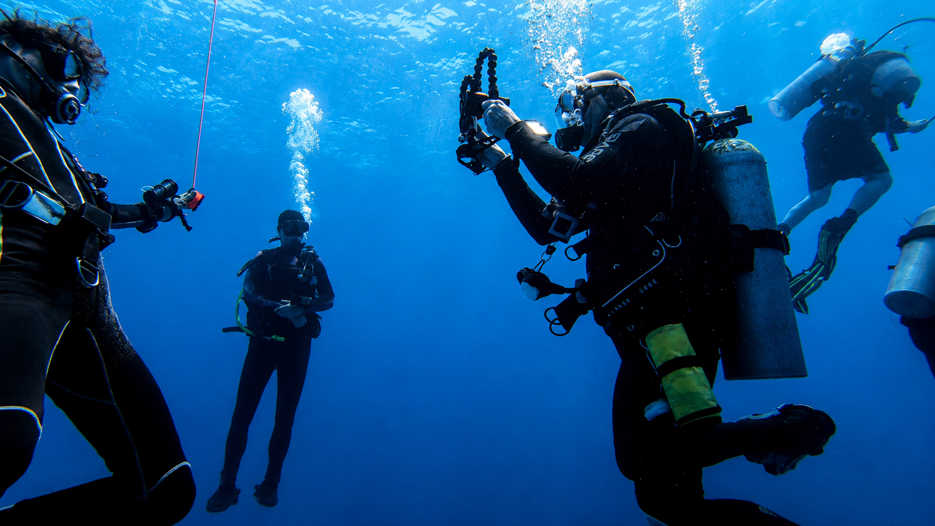 Divers pausing together in clear blue water