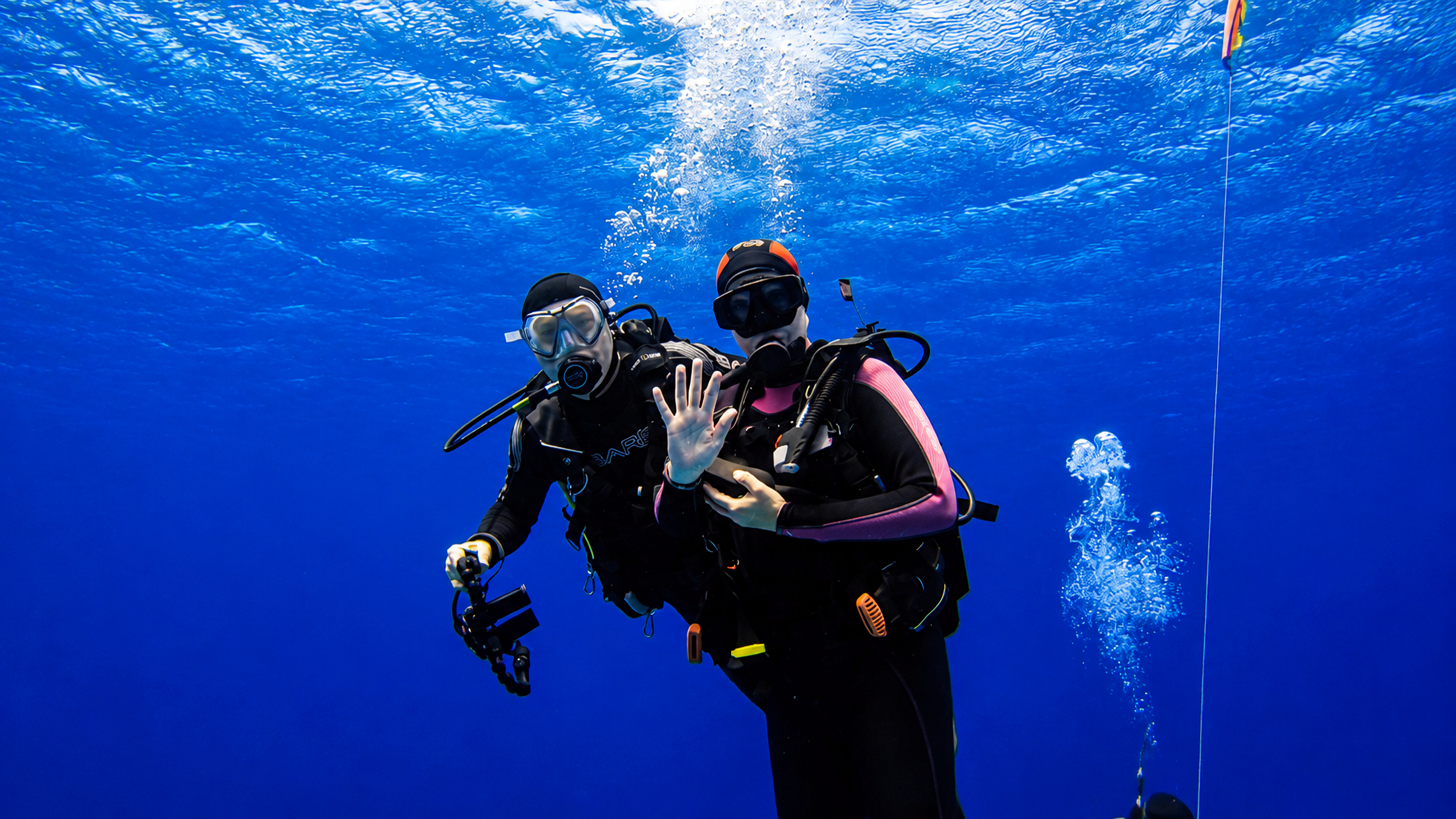 Two divers together during a safety stop in Cozumel